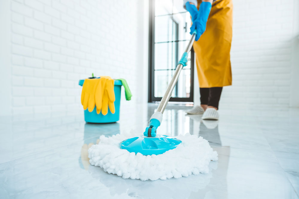 Person cleaning floor after builders work